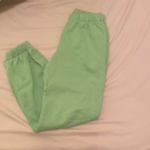 Brandy Melville sweatpants in the jogger category. They are lime green.